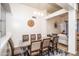Dining room featuring an 8 person table with travertine flooring and decorative wall clock at 19824 N 14Th Pl, Phoenix, AZ 85024