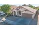 Beautiful view of the tan stucco home featuring a two car garage and a well manicured front yard at 19824 N 14Th Pl, Phoenix, AZ 85024