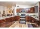 Kitchen featuring wood cabinets, granite counters and stainless steel appliances in an open space at 19824 N 14Th Pl, Phoenix, AZ 85024