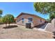 A well maintained backyard with desert landscaping and exterior of home with air conditioning unit at 1983 W Allens Peak Rd, Queen Creek, AZ 85144