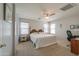 Spacious bedroom with a large bed, ceiling fan and natural light from the windows at 1983 W Allens Peak Rd, Queen Creek, AZ 85144