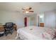 Bright bedroom with a ceiling fan, desk and view into the bathroom at 1983 W Allens Peak Rd, Queen Creek, AZ 85144