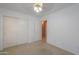 Well-lit bedroom featuring a ceiling fan and double closets, offering ample storage at 1983 W Allens Peak Rd, Queen Creek, AZ 85144