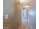 Hallway features tiled flooring and updated sconce lighting, leading to various rooms in the house at 1983 W Allens Peak Rd, Queen Creek, AZ 85144