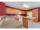 Kitchen with an island, white appliances, and lots of oak cabinets for storage at 1983 W Allens Peak Rd, Queen Creek, AZ 85144
