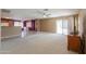 Spacious living room featuring neutral carpet, ceiling fan, and sliding glass doors to the backyard at 1983 W Allens Peak Rd, Queen Creek, AZ 85144