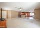 Spacious living area with carpet and a tiled kitchen with wooden cabinets at 1983 W Allens Peak Rd, Queen Creek, AZ 85144