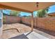 Covered patio area offering respite from the sun and an open backyard and desert landscaping at 1983 W Allens Peak Rd, Queen Creek, AZ 85144