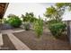 Well-maintained backyard featuring mature trees, gravel landscaping, paver walkways, and a block wall fence for privacy at 21050 E Tierra Grande --, Queen Creek, AZ 85142