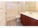 Clean bathroom featuring a shower-tub combo, wood-grain flooring, and a vanity with ample storage at 21050 E Tierra Grande --, Queen Creek, AZ 85142