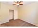 Carpeted bedroom featuring a closet with sliding doors and a ceiling fan at 21050 E Tierra Grande --, Queen Creek, AZ 85142