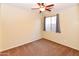 Bedroom with neutral walls and carpet, a ceiling fan, and a window with curtains at 21050 E Tierra Grande --, Queen Creek, AZ 85142