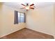 Cozy bedroom with neutral walls, a ceiling fan, and a window offering plenty of natural light at 21050 E Tierra Grande --, Queen Creek, AZ 85142