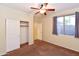 Bedroom featuring a ceiling fan, closet with sliding doors, neutral walls and carpet at 21050 E Tierra Grande --, Queen Creek, AZ 85142
