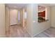 Inviting entryway features wood-look flooring, neutral paint, and a convenient pass-through to the kitchen at 21050 E Tierra Grande --, Queen Creek, AZ 85142