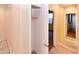 Bright hallway with entry to a closet with a clothes bar, a window, and wood look floors at 21050 E Tierra Grande --, Queen Creek, AZ 85142