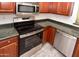 Close-up of oven, microwave, countertops, and cabinets in a modern kitchen at 21050 E Tierra Grande --, Queen Creek, AZ 85142