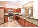 Well-equipped kitchen featuring stainless steel appliances, wood cabinets, and granite countertops at 21050 E Tierra Grande --, Queen Creek, AZ 85142