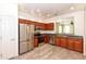 Bright kitchen with stainless steel appliances, wood cabinets and view to living room at 21050 E Tierra Grande --, Queen Creek, AZ 85142