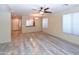 Spacious living room featuring contemporary flooring, a ceiling fan, and ample natural light at 21050 E Tierra Grande --, Queen Creek, AZ 85142