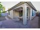 Inviting covered patio with brick pavers, a dining set, and views of the landscaped backyard at 21050 E Tierra Grande --, Queen Creek, AZ 85142