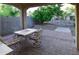 Charming covered patio with brick pavers, dining furniture, and a view of lush greenery at 21050 E Tierra Grande --, Queen Creek, AZ 85142