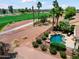 View of this backyard pool with mature landscaping and the golf course in the background at 22504 N San Ramon Dr, Sun City West, AZ 85375