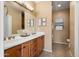 Bathroom with double vanity, decorative mirrors, and a shower with glass doors at 22504 N San Ramon Dr, Sun City West, AZ 85375