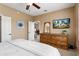 This bedroom has a ceiling fan and a dresser with a mirror and television at 22504 N San Ramon Dr, Sun City West, AZ 85375