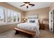 Cozy bedroom with a ceiling fan, bright light from the windows, and a decorative wood bench at 22504 N San Ramon Dr, Sun City West, AZ 85375