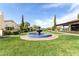 Scenic courtyard view showcases a tiered fountain, lush green spaces, and charming buildings, a perfect spot for relaxation at 22504 N San Ramon Dr, Sun City West, AZ 85375