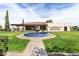 Beautiful courtyard featuring a blue tiled fountain, surrounded by green lawns and elegant architecture at 22504 N San Ramon Dr, Sun City West, AZ 85375