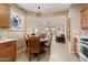 Dining area with a view to the living room featuring an open layout to the kitchen at 22504 N San Ramon Dr, Sun City West, AZ 85375