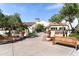 Inviting exterior showcasing lush landscaping, a stucco facade, and stylish benches in a welcoming community setting at 22504 N San Ramon Dr, Sun City West, AZ 85375