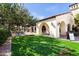 Lush lawn area of a community space with charming architecture and seating, perfect for relaxing outdoors at 22504 N San Ramon Dr, Sun City West, AZ 85375