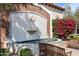 Charming outdoor fountain surrounded by lush greenery and colorful bougainvillea blossoms offers a serene escape at 22504 N San Ramon Dr, Sun City West, AZ 85375