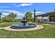 Beautiful outdoor fountain in a meticulously landscaped setting with a covered patio area for relaxing outdoors at 22504 N San Ramon Dr, Sun City West, AZ 85375