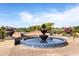 Beautiful tiered fountain with blue tile accents overlooks the lush green golf course on a sunny day at 22504 N San Ramon Dr, Sun City West, AZ 85375