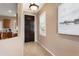 Home foyer featuring a dark wood door and view into the kitchen at 22504 N San Ramon Dr, Sun City West, AZ 85375