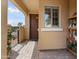 Inviting covered front porch with stone pavers and a charming dark wood door at 22504 N San Ramon Dr, Sun City West, AZ 85375