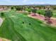 Scenic aerial view of a meticulously maintained golf course with lush green fairways and mature trees at 22504 N San Ramon Dr, Sun City West, AZ 85375