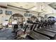 Well-equipped gym with treadmills, stationary bikes, and weight machines, all with mounted TV's for resident entertainment at 22504 N San Ramon Dr, Sun City West, AZ 85375