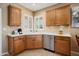 Kitchen area featuring wood cabinets, modern countertops, and stainless steel appliances at 22504 N San Ramon Dr, Sun City West, AZ 85375