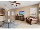Spacious living room featuring tile flooring, media center, and sliding glass doors at 22504 N San Ramon Dr, Sun City West, AZ 85375