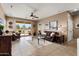 Open living room with tile floors, a ceiling fan, and sliding glass doors to the patio at 22504 N San Ramon Dr, Sun City West, AZ 85375