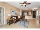Open-concept living room showcases tile flooring, a leather sofa, and kitchen views at 22504 N San Ramon Dr, Sun City West, AZ 85375