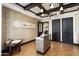 A modern clubhouse lobby has tile floors and a reception desk with the Bella Vista logo on the wall at 22504 N San Ramon Dr, Sun City West, AZ 85375