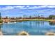 Scenic view of a well-manicured golf course with a serene pond and upscale homes as a backdrop at 22504 N San Ramon Dr, Sun City West, AZ 85375
