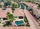 Overhead view of a relaxing backyard including a pool, patio, desert landscaping, and tree-lined streets at 22504 N San Ramon Dr, Sun City West, AZ 85375