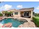 Gorgeous backyard and custom pool with boulders and lush plants at 22504 N San Ramon Dr, Sun City West, AZ 85375